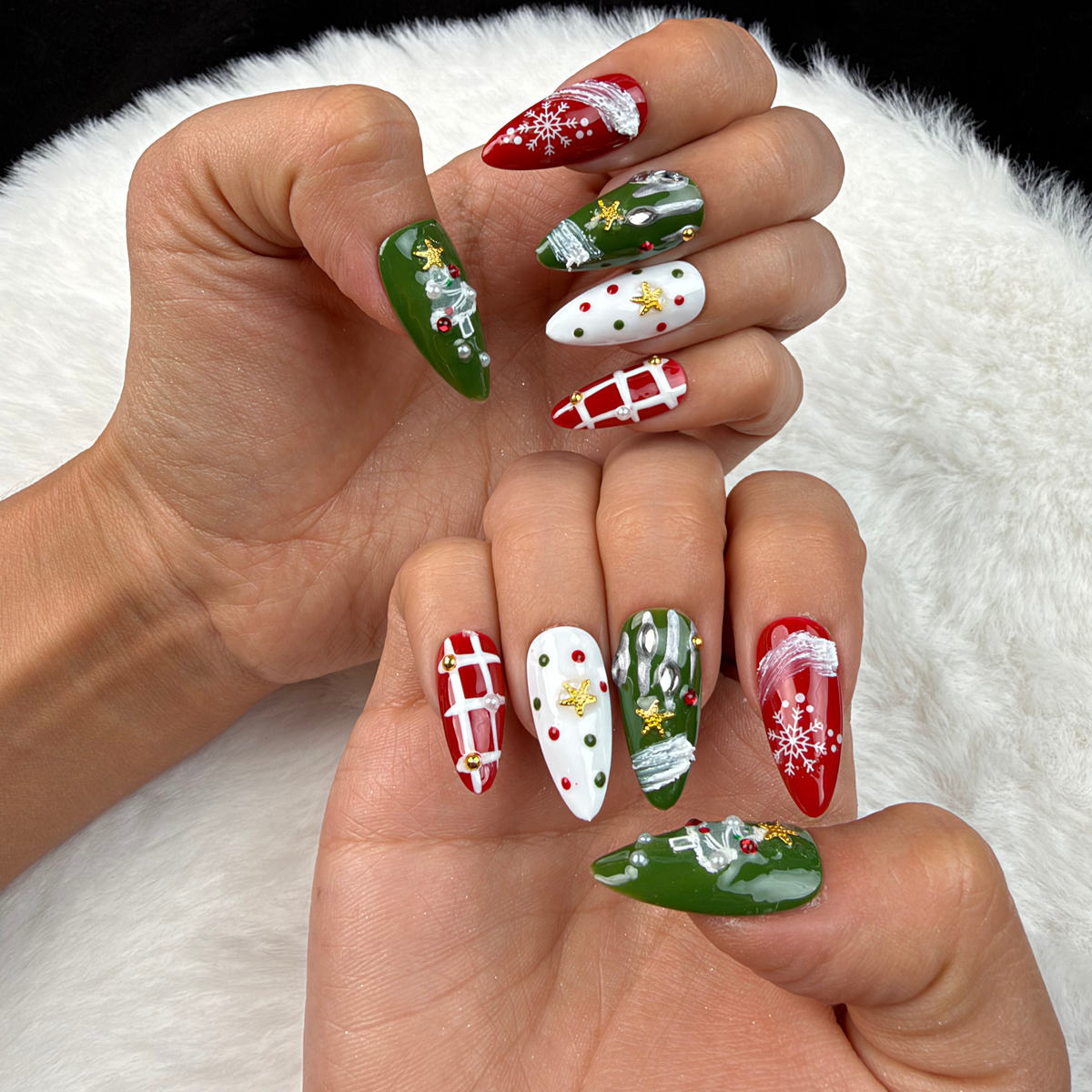 Hands wearing Winter Parcel red and green ribbon and plaid Christmas almond press-on nails