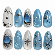Blue Orbit icy blue cat eye celestial almond press-on nails with silver details