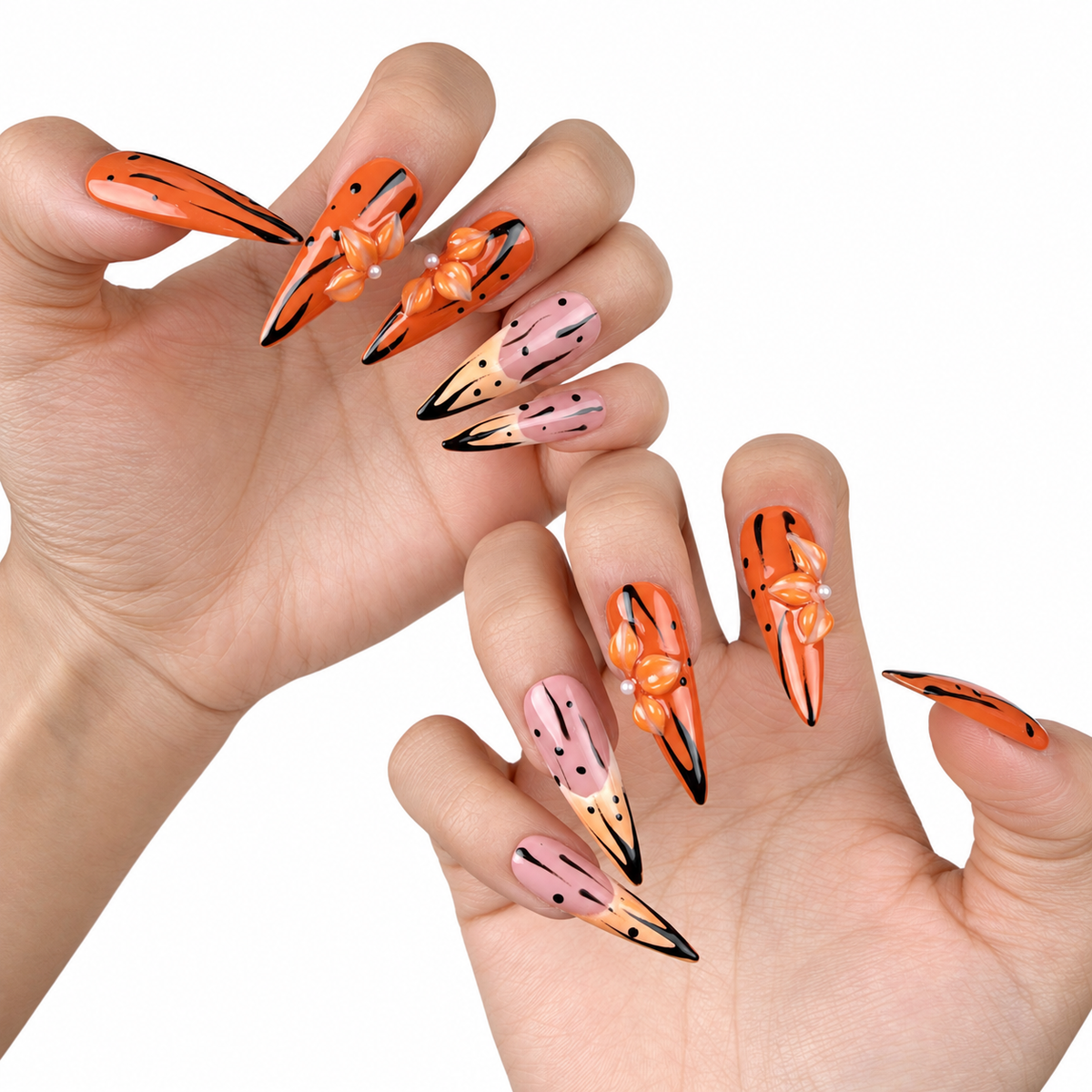 Hands wearing Tangerine Edge orange chrome and nude pink stiletto press-on nails with black floral details
