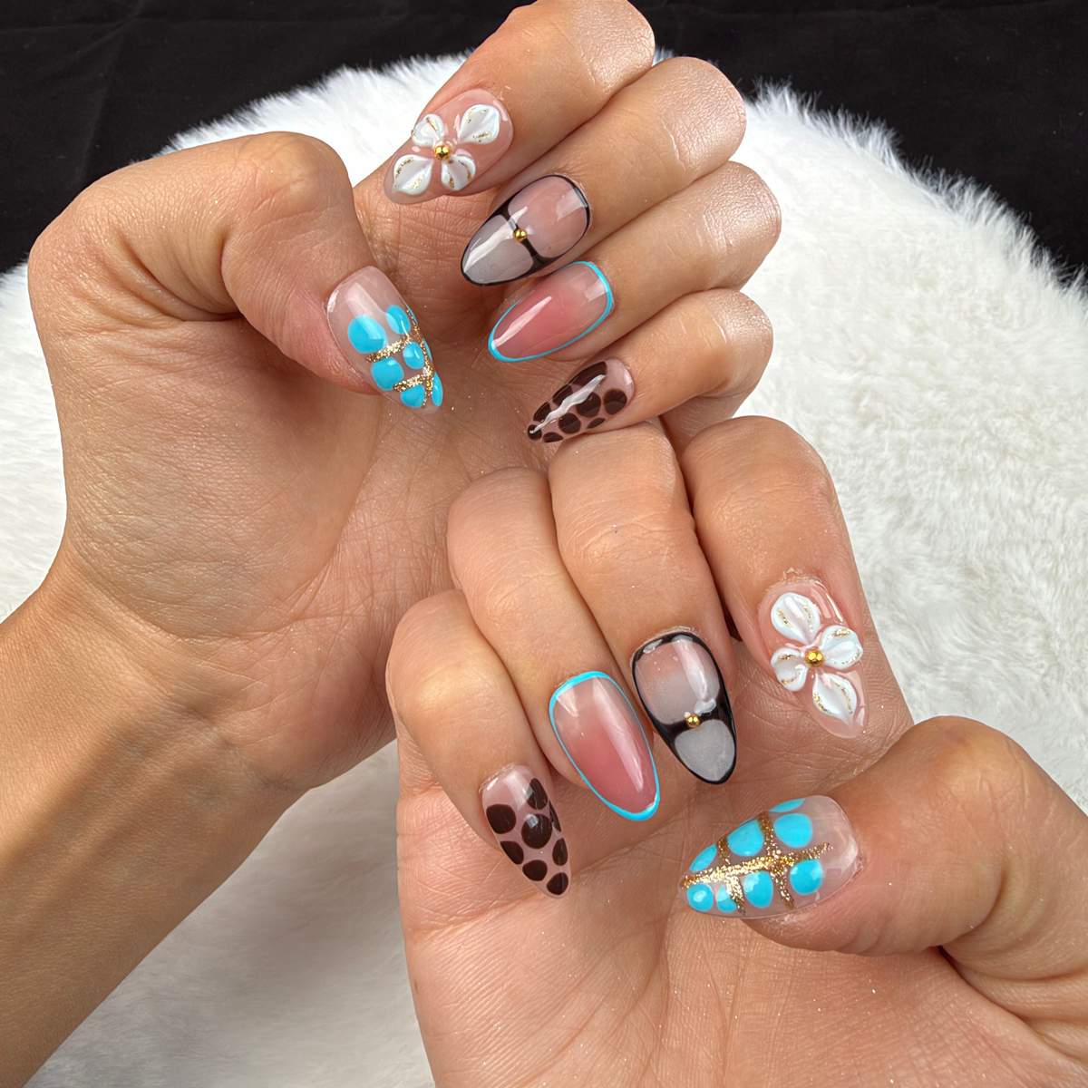 Hands wearing Turquoise Mix turquoise, leopard print and floral almond press-on nails