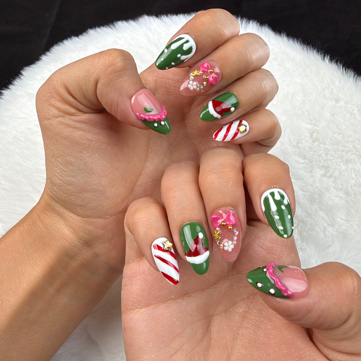 Hands wearing Festive Candy green and red candy cane Christmas almond press-on nails