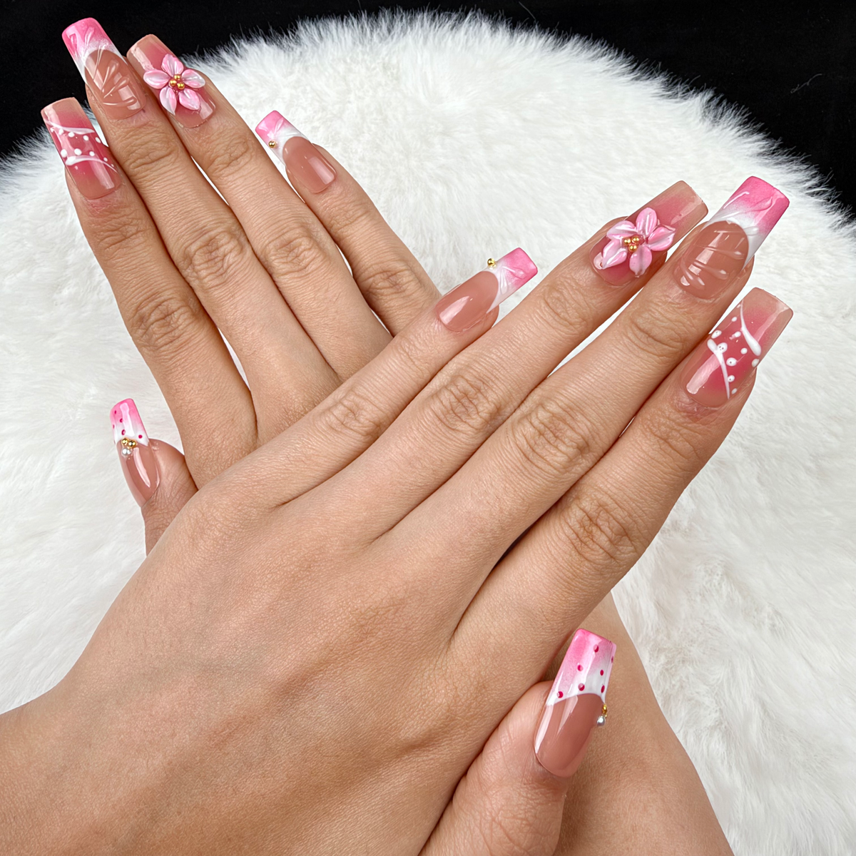 Hands wearing Rose Trellis pink floral and white linework square press-on nails
