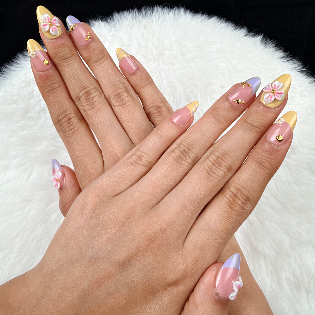 Hands wearing Lilac Lemon lilac and yellow French tip floral almond press-on nails