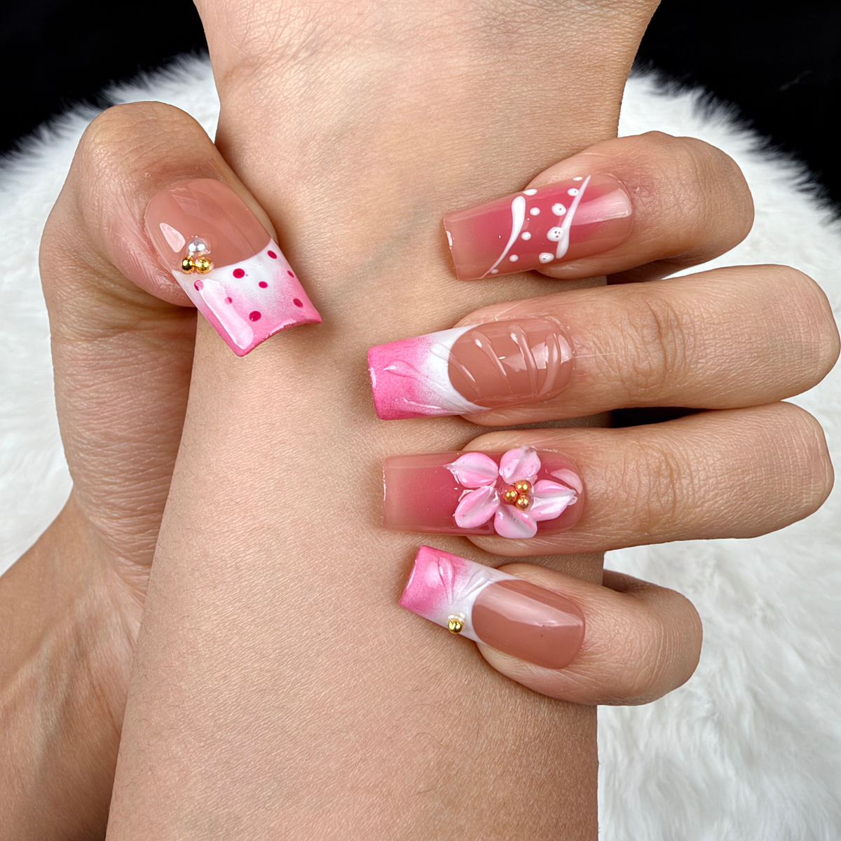 Detail shot of Rose Trellis pink floral and white linework square press-on nails on hand