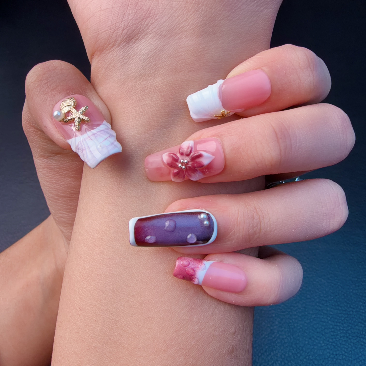 Hands wearing Rose Tide pink, plum and pearl white 3D floral long square press-on nails