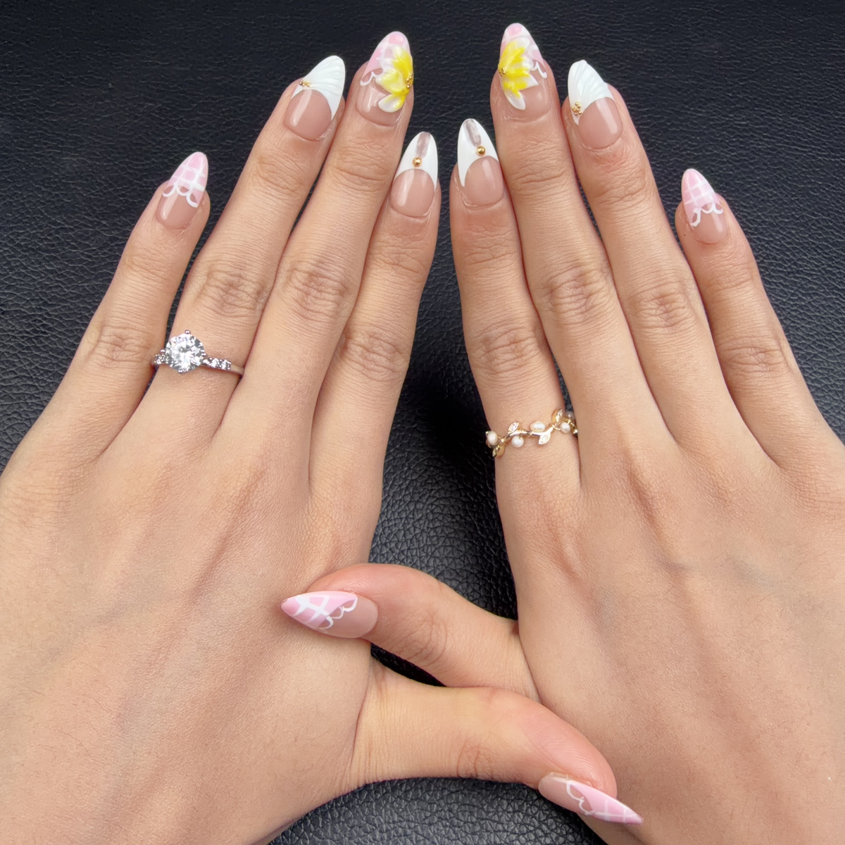 Hands wearing Buttercream Bloom pink, white and yellow 3D floral medium almond press-on nails