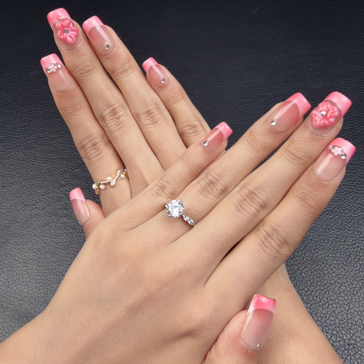 Hands wearing Rose pink French tip 3D floral medium square press-on nails