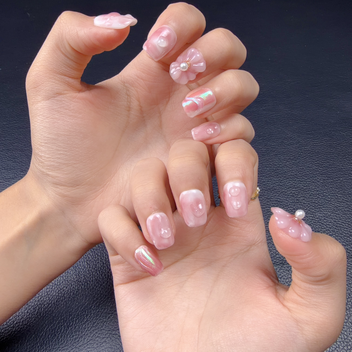 Hands wearing Blush pink jelly 3D floral pearl short square press-on nails