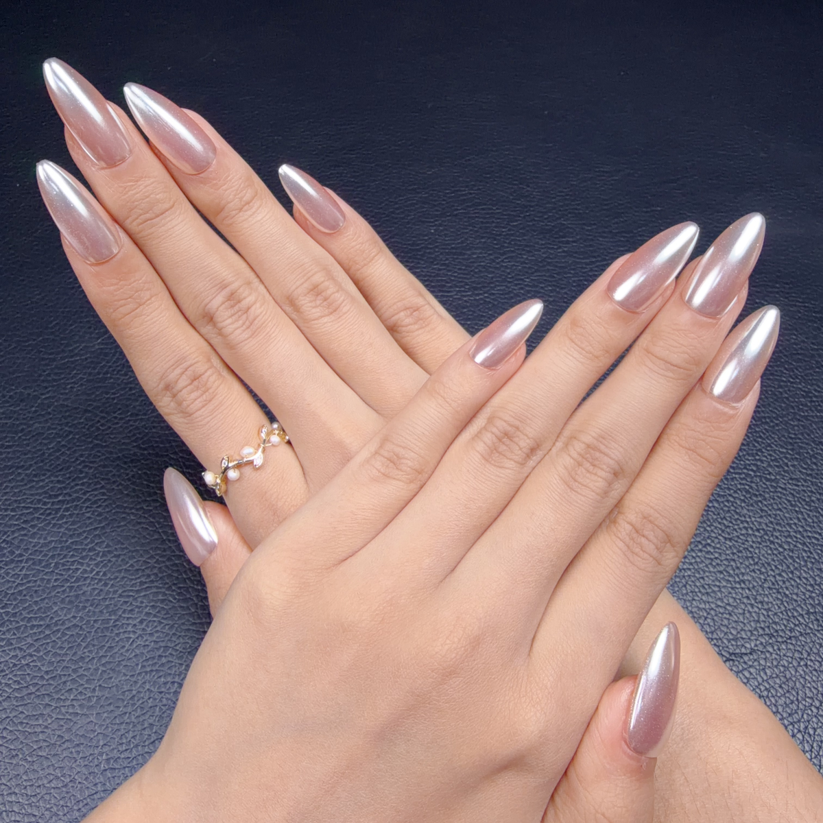 Hands wearing Pearl lilac chrome long almond press-on nails
