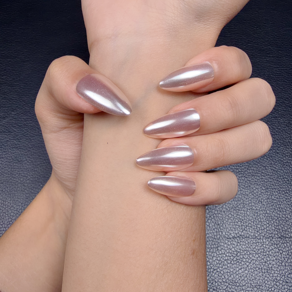 Hands wearing Pearl lilac chrome long almond press-on nails