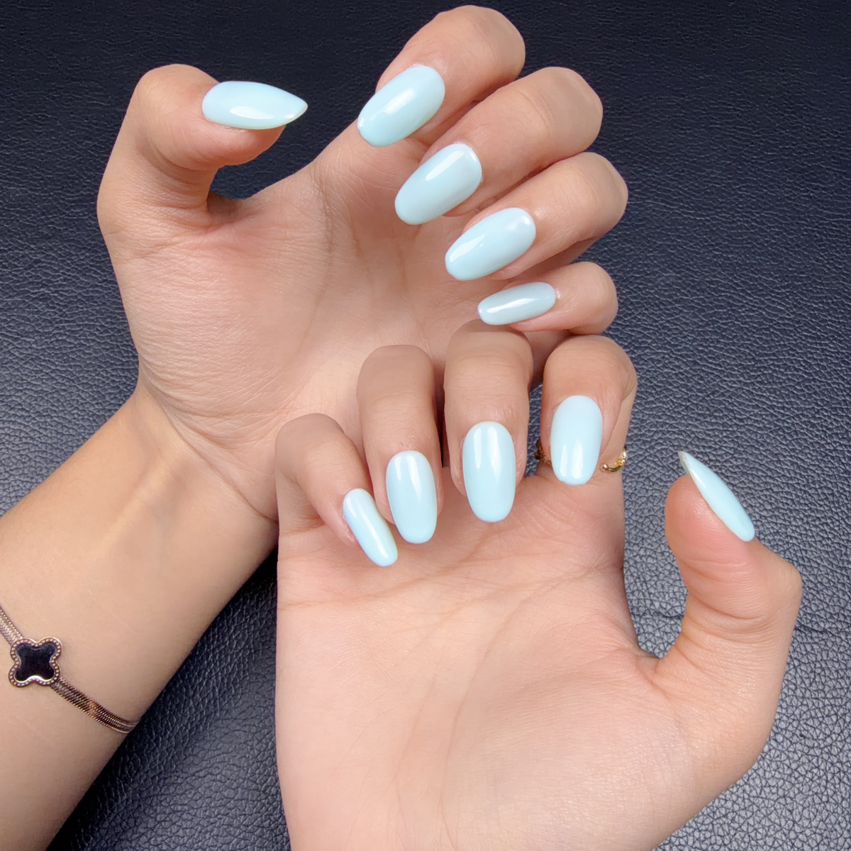 Hands wearing Soft light blue glossy solid color press-on nails