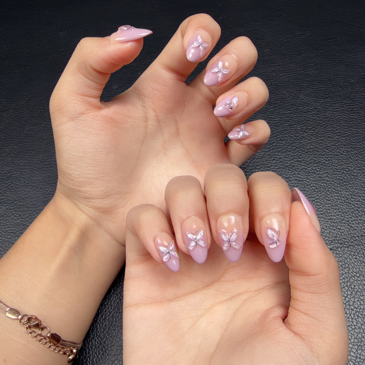 Hands wearing Lavender butterfly ombre nude pink and lilac almond press-on nails