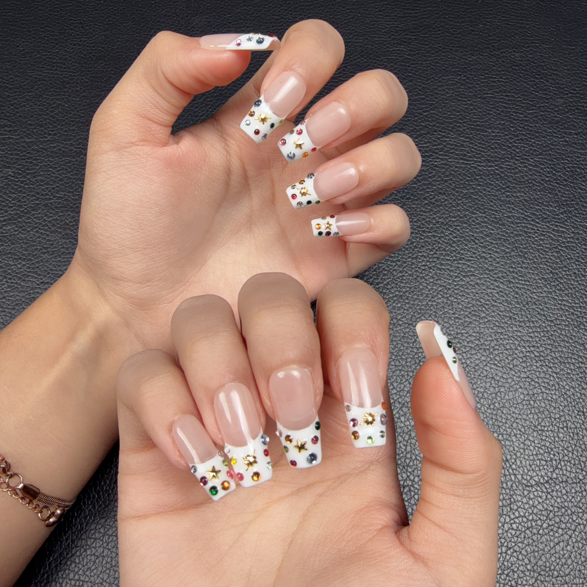 Hands wearing Confetti French colorful floral French tip medium square press-on nails