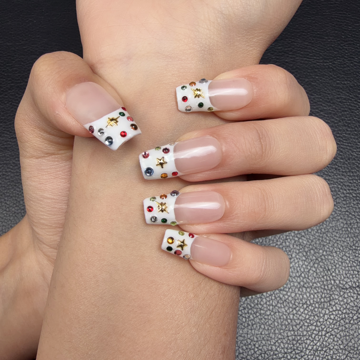 Hands wearing Confetti French colorful floral French tip medium square press-on nails