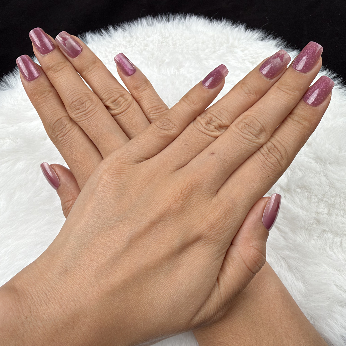 Detail shot of Rose Wings rose pink cat eye square press-on nails with butterfly accents on hand