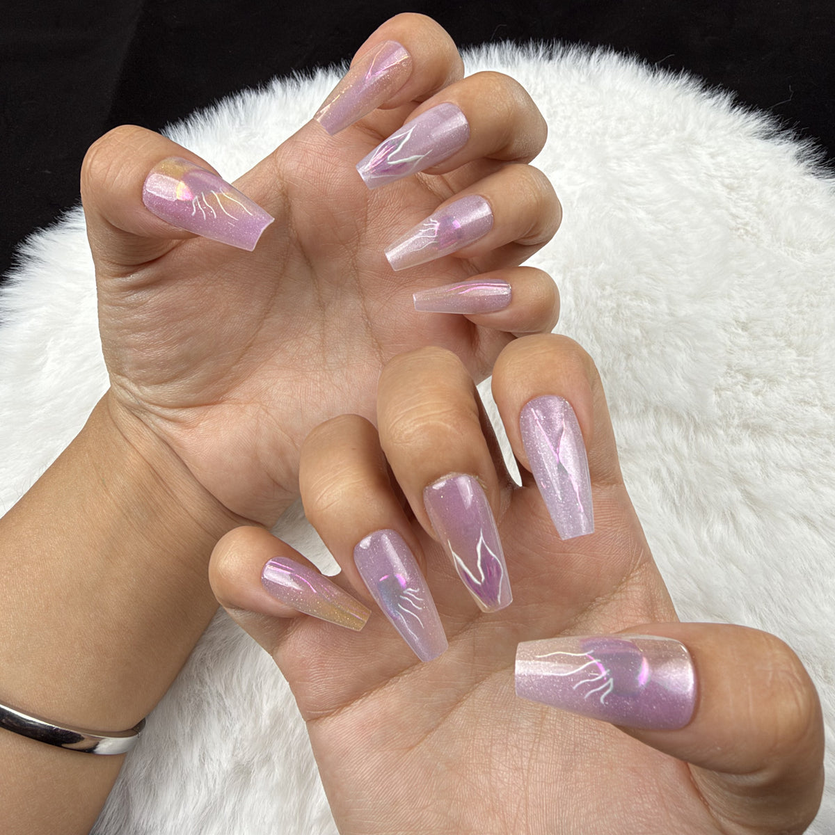 Hands wearing Iris Lightning lavender iridescent abstract coffin press-on nails