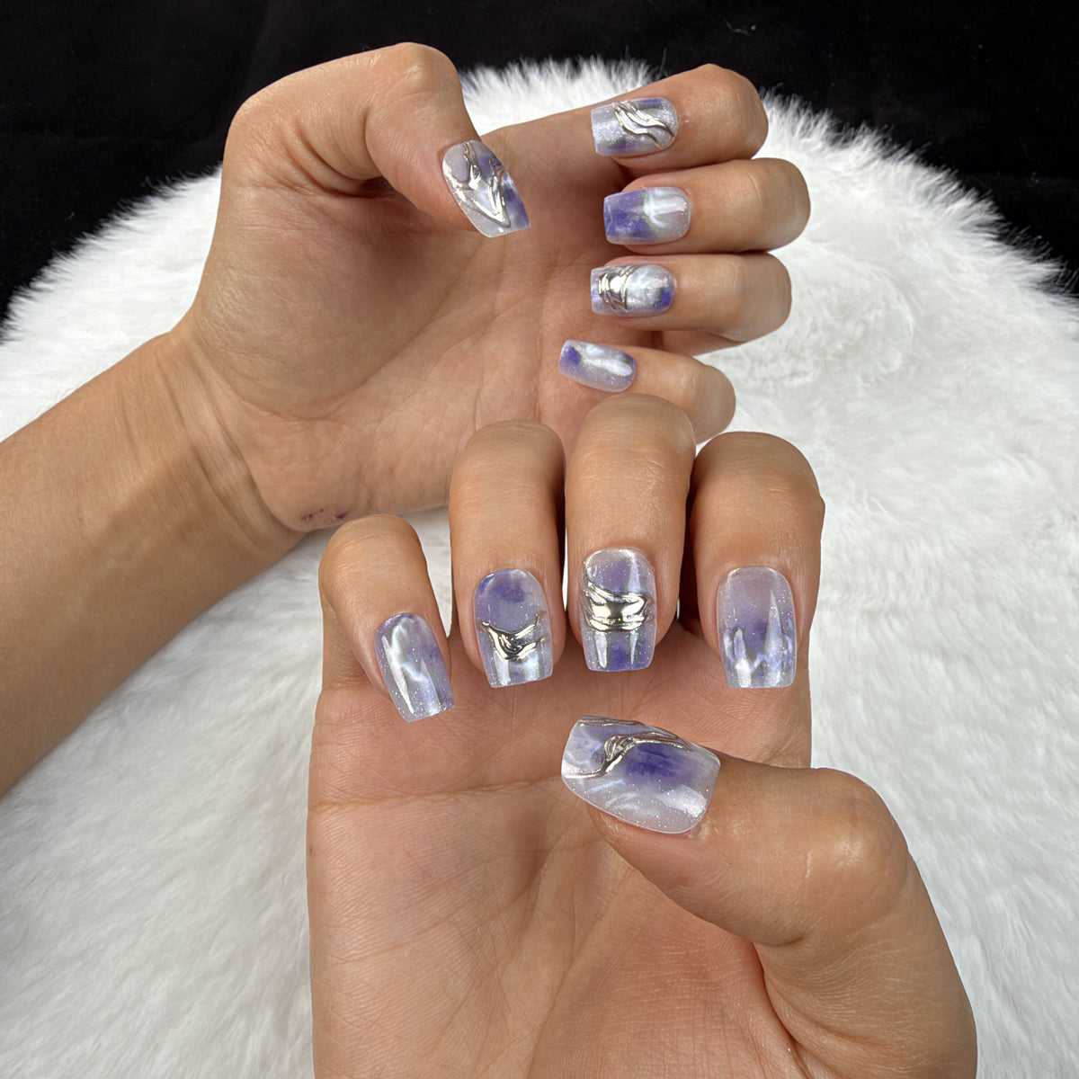 Hands wearing Violet Marble blue-violet marble square press-on nails
