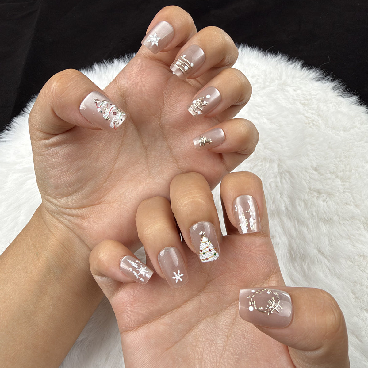 Hands wearing Champagne Fir champagne tree and snowflake Christmas square press-on nails