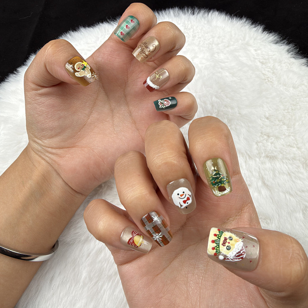 Hands wearing Holiday Patchwork plaid and festive Christmas square press-on nails