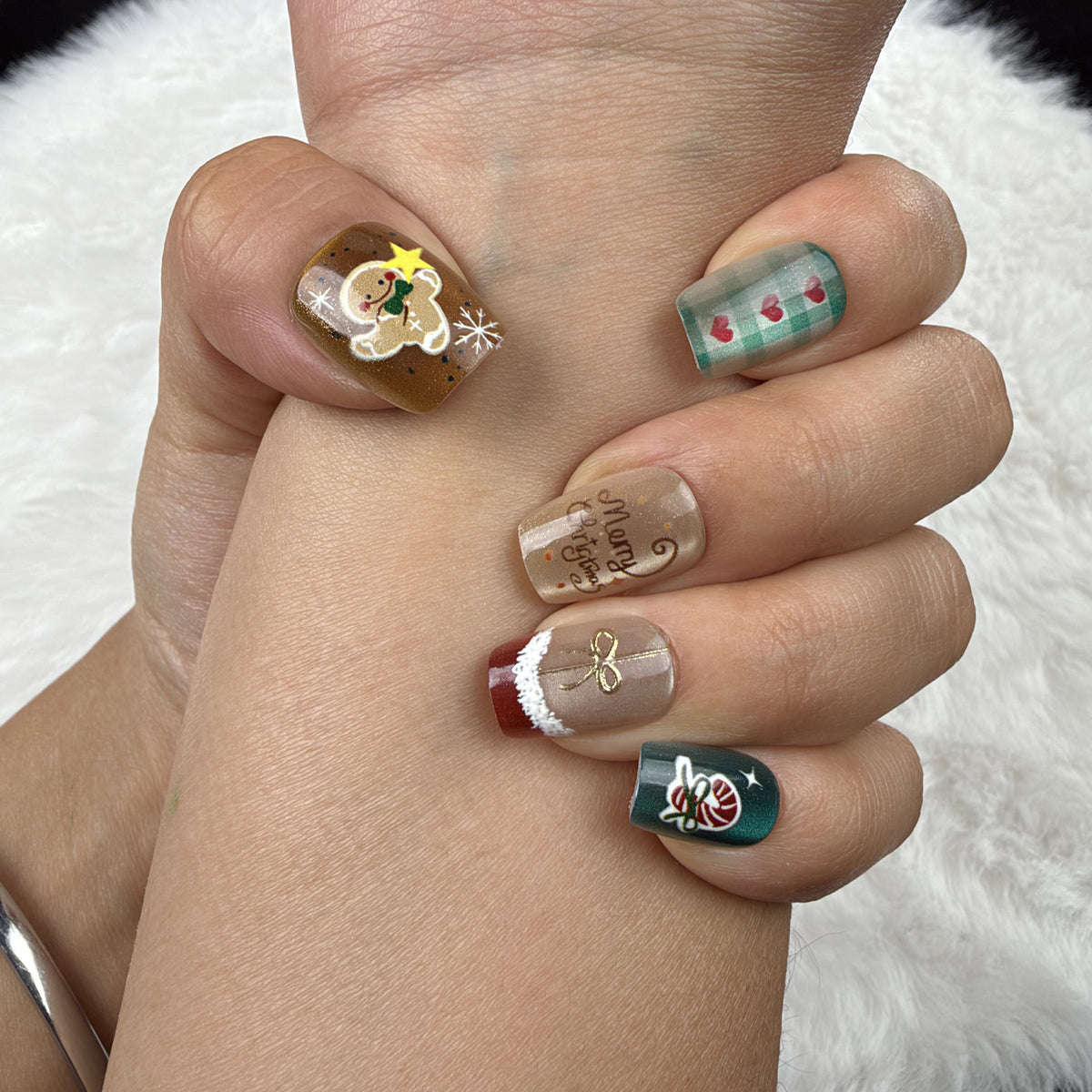 Close-up of hands wearing Holiday Patchwork plaid and festive Christmas square press-on nails