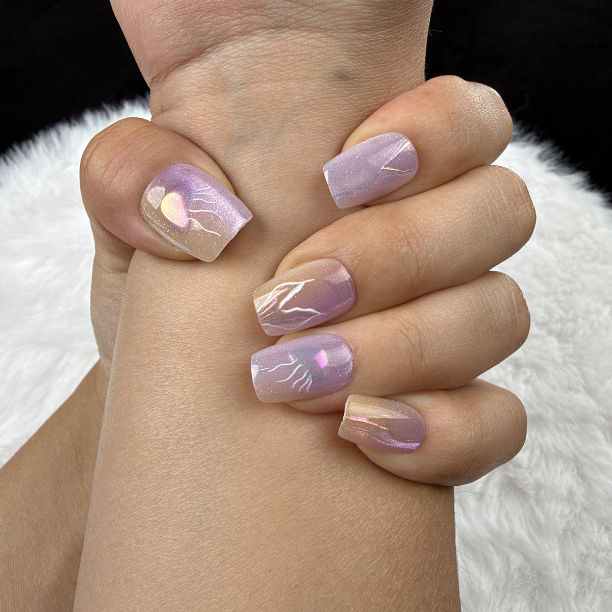 Close-up of hands wearing Lavender Flash lavender iridescent abstract square press-on nails