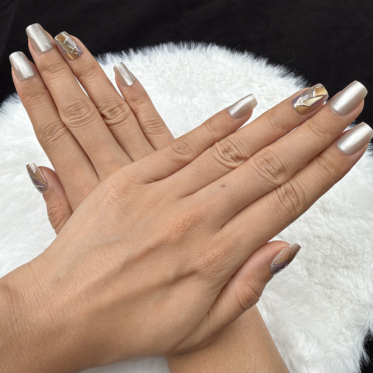 Detail shot of Pearl Mosaic pearl white and gold-tone geometric square press-on nails on hand