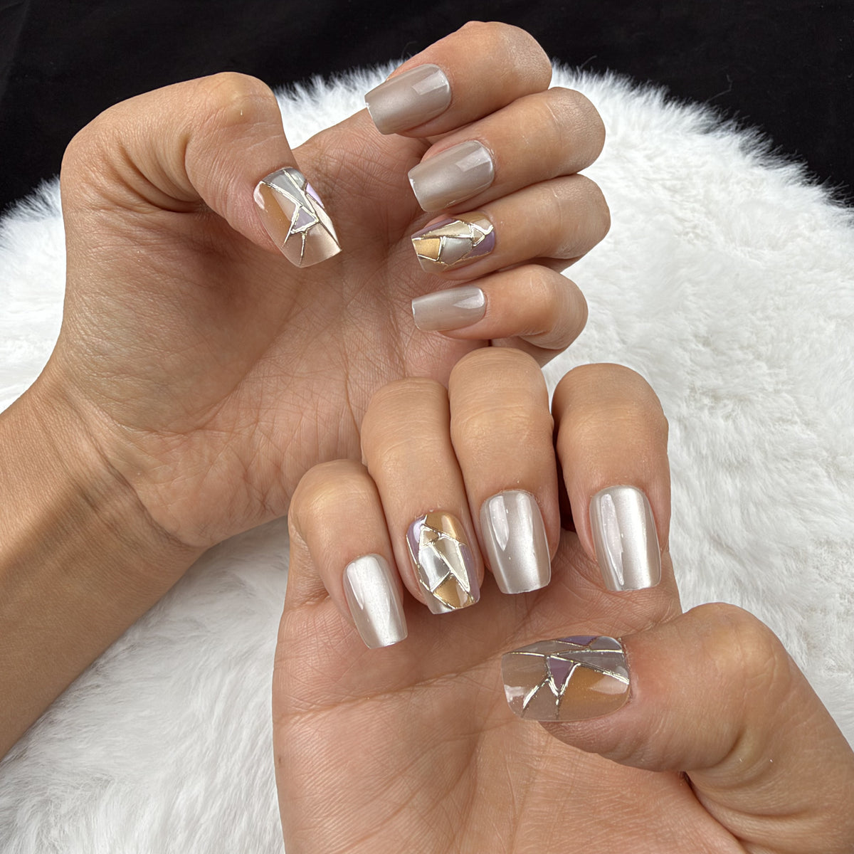 Hands wearing Pearl Mosaic pearl white and gold-tone geometric square press-on nails