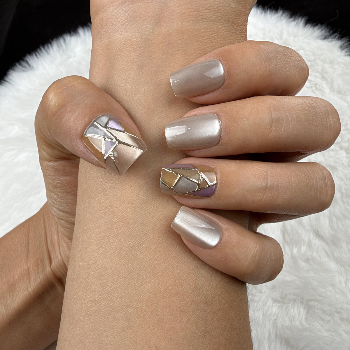 Close-up of hands wearing Pearl Mosaic pearl white and gold-tone geometric square press-on nails