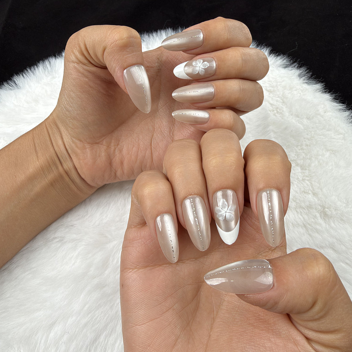 Hands wearing Pearl Petal nude pearl French tip almond press-on nails