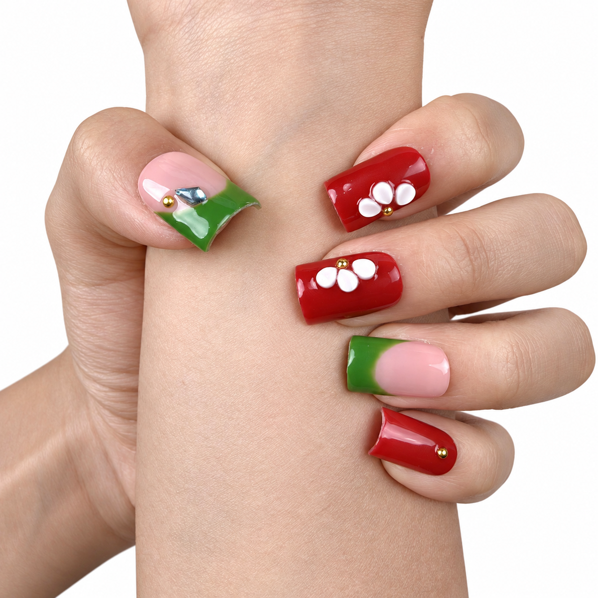 Detail shot of Garden Contrast red, green and white floral square press-on nails on hand