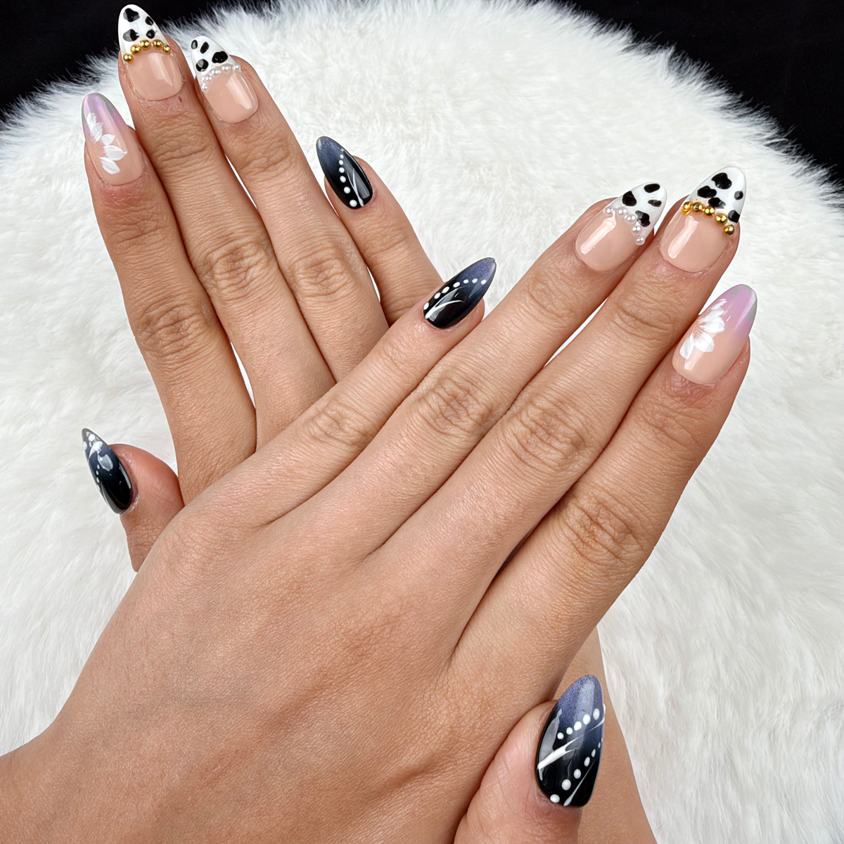 Hands wearing Monochrome Meadow black and white floral almond press-on nails