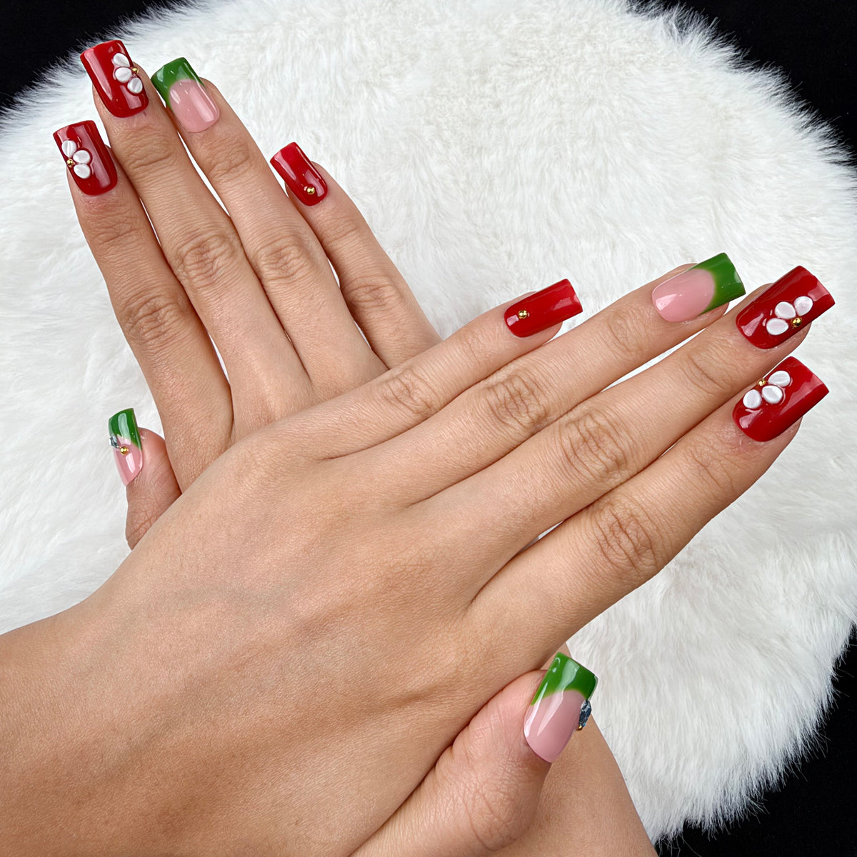 Hands wearing Garden Contrast red, green and white floral square press-on nails