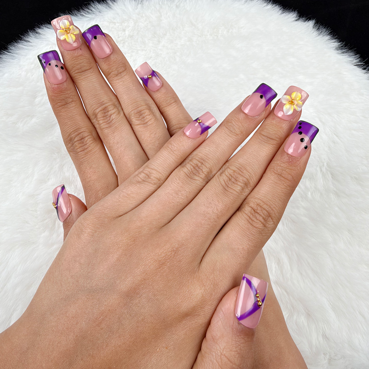 Hands wearing Violet Ribbon purple and yellow floral square press-on nails