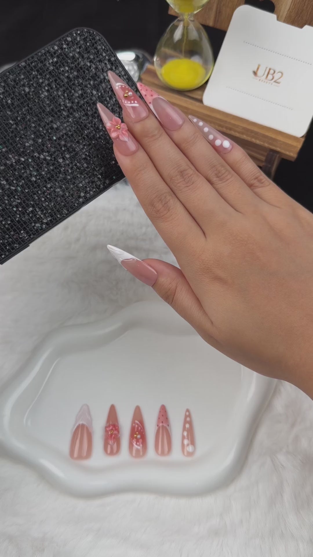 Load video: Step-by-step application of Peach Bloom nude pink and white French floral almond press-on nails