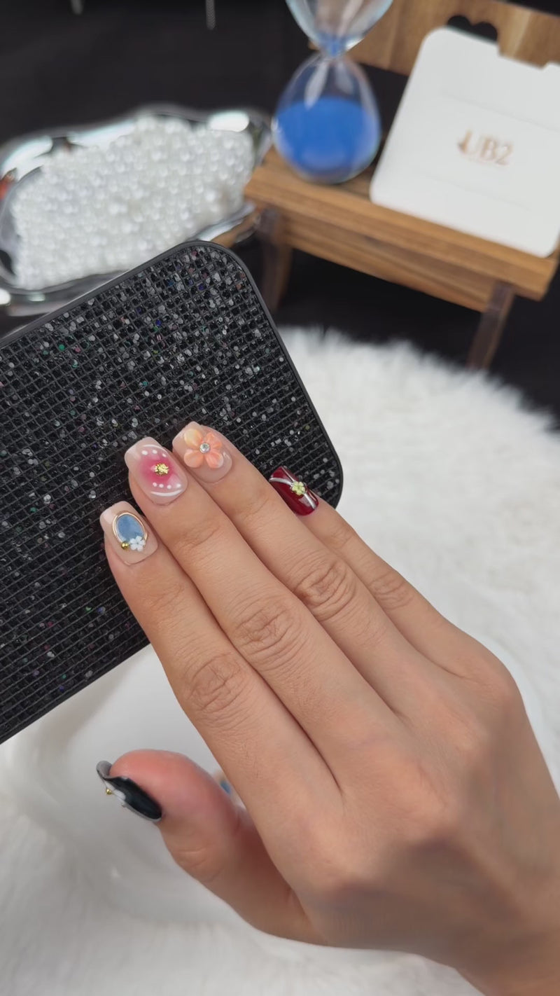 Step-by-step application of Blossom Mosaic nude, burgundy and black floral square press-on nails