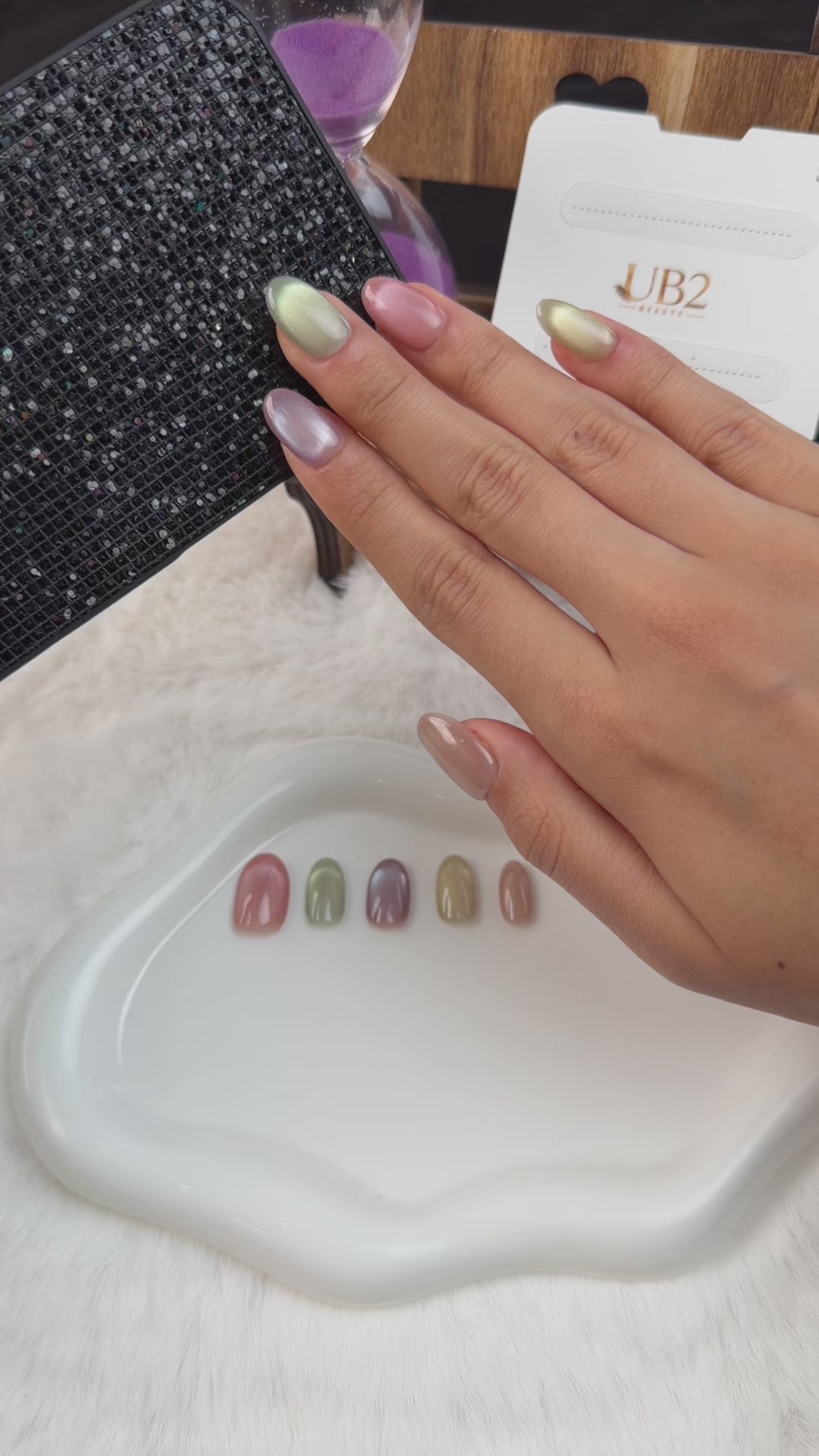 Load video: Step-by-step application of Multicolor cat eye oval press-on nails in pink, sage green, lavender and champagne