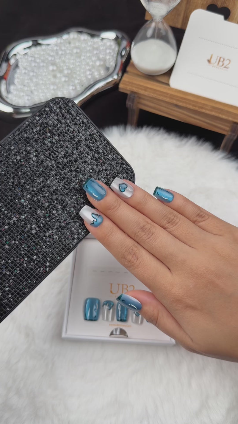 Step-by-step application of Blue Heart Drip blue chrome and pearl white heart square press-on nails