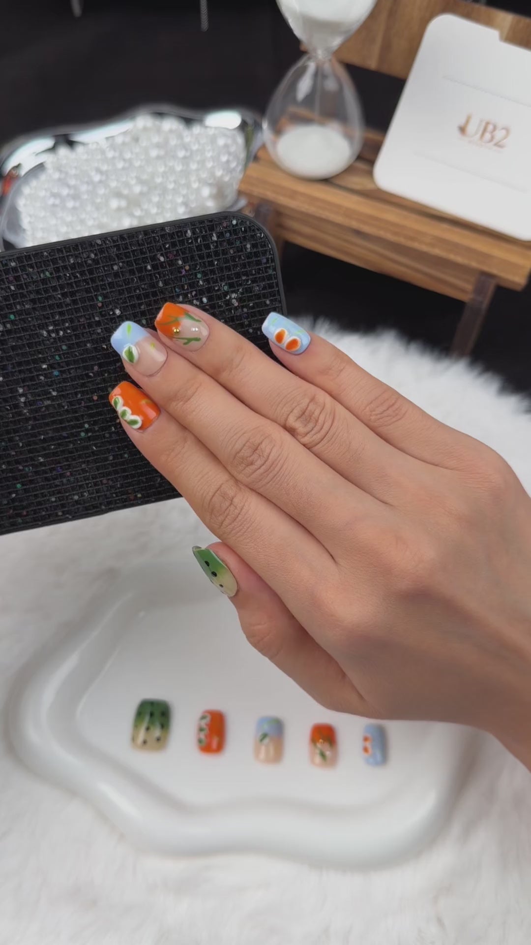 Load video: Step-by-step application of Summer Orchard orange, blue and green floral square press-on nails