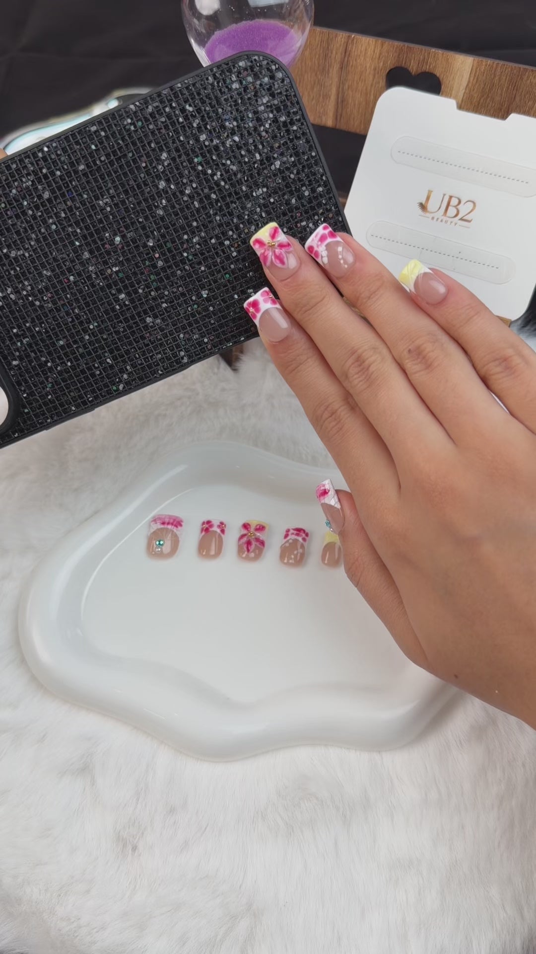 Load video: Step-by-step application of Pink heart graphic floral almond press-on nails with yellow French accents