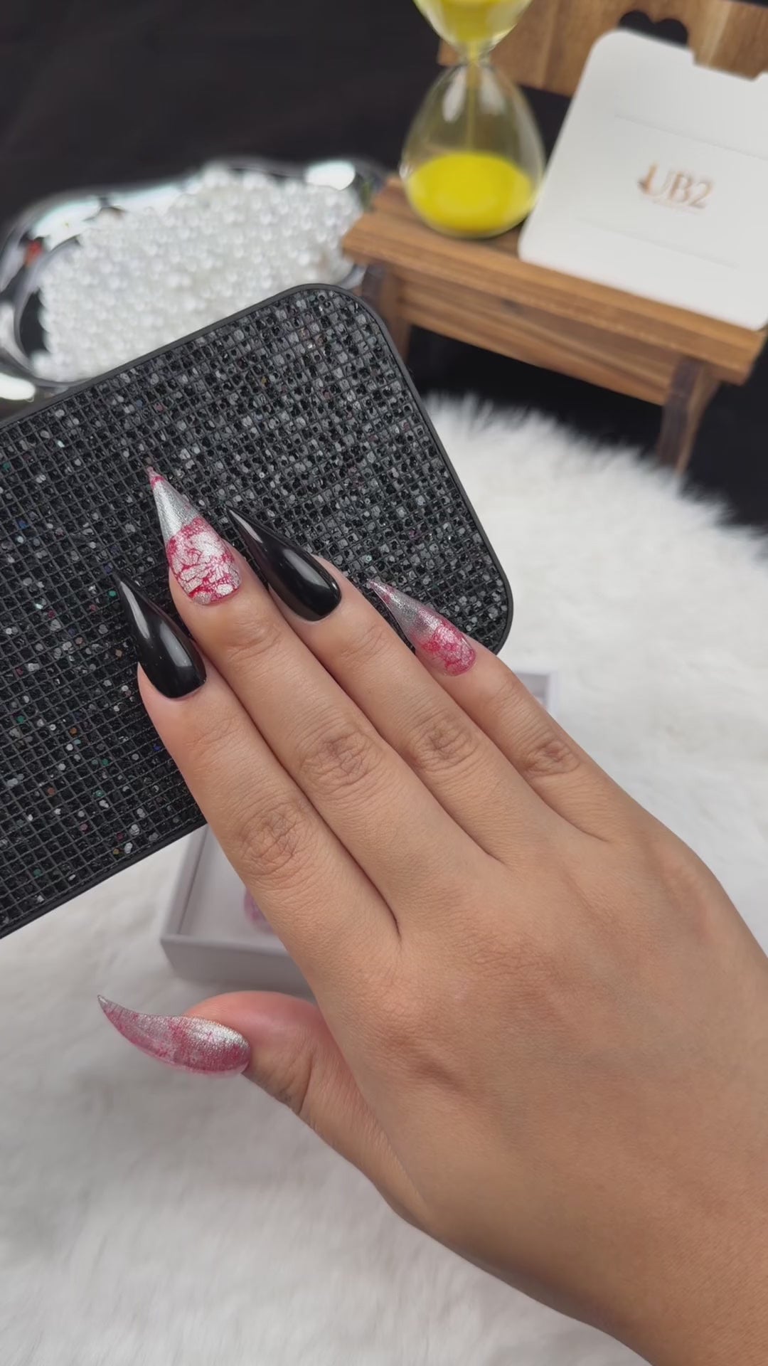 Load video: Step-by-step application of Rose Static pink and silver crackle and black stiletto press-on nails