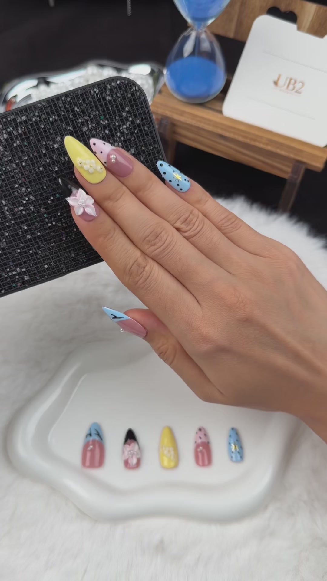 Load video: Step-by-step application of Pastel Graphic Garden blue, yellow and pink floral almond press-on nails