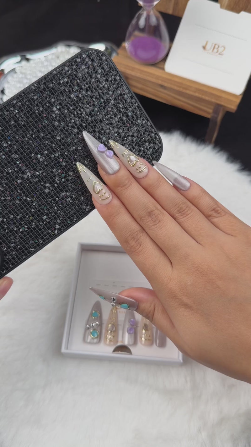 Step-by-step application of Silver Muse silver chrome stiletto press-on nails with turquoise stones and a heart charm
