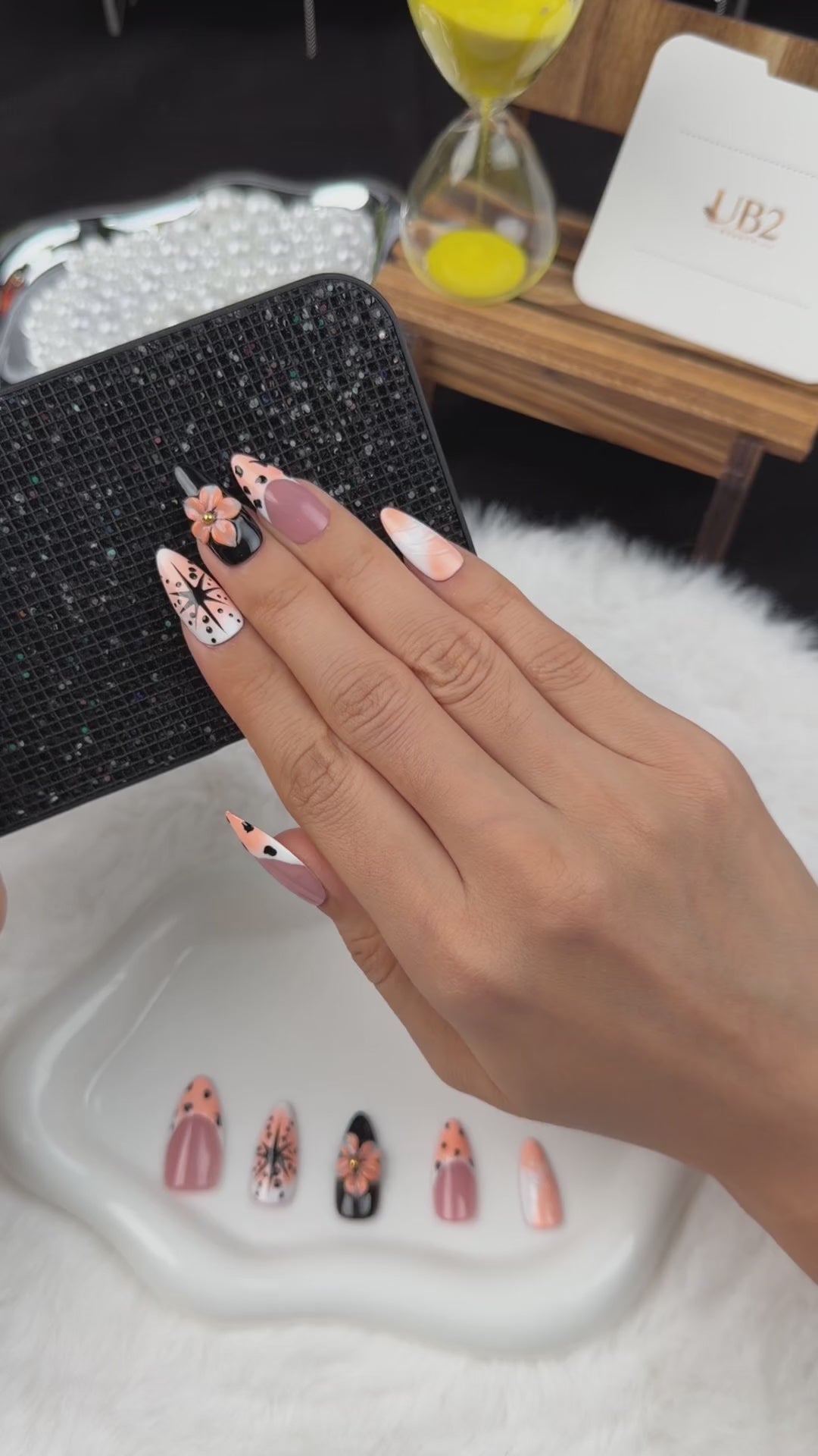 Load video: Step-by-step application of Peach Graphic Bloom peach and black floral almond press-on nails