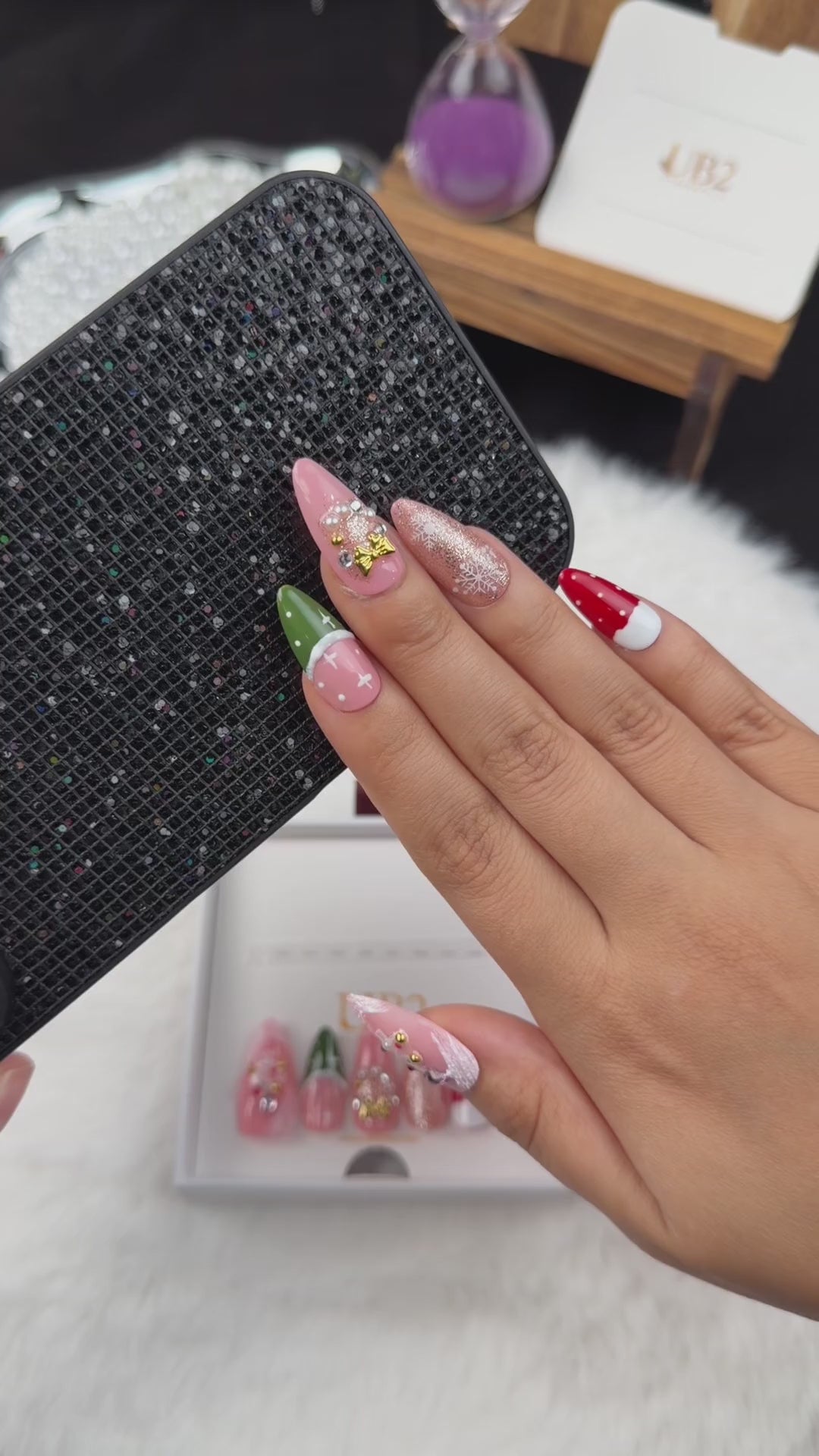 Load video: Step-by-step application of Pink Noel pink, red and green Christmas almond press-on nails