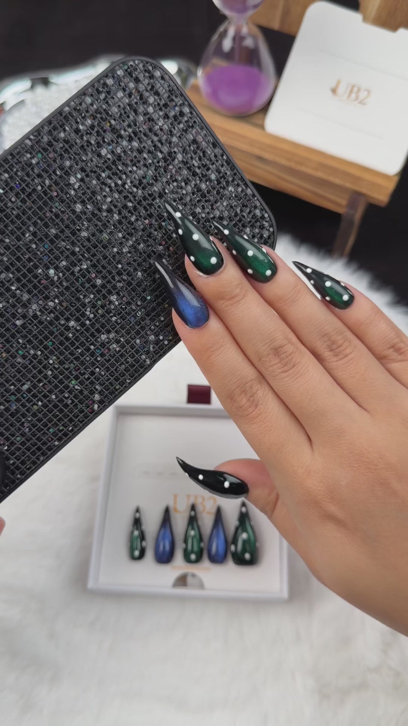Step-by-step application of Emerald After Dark green and blue cat eye stiletto press-on nails with rhinestones