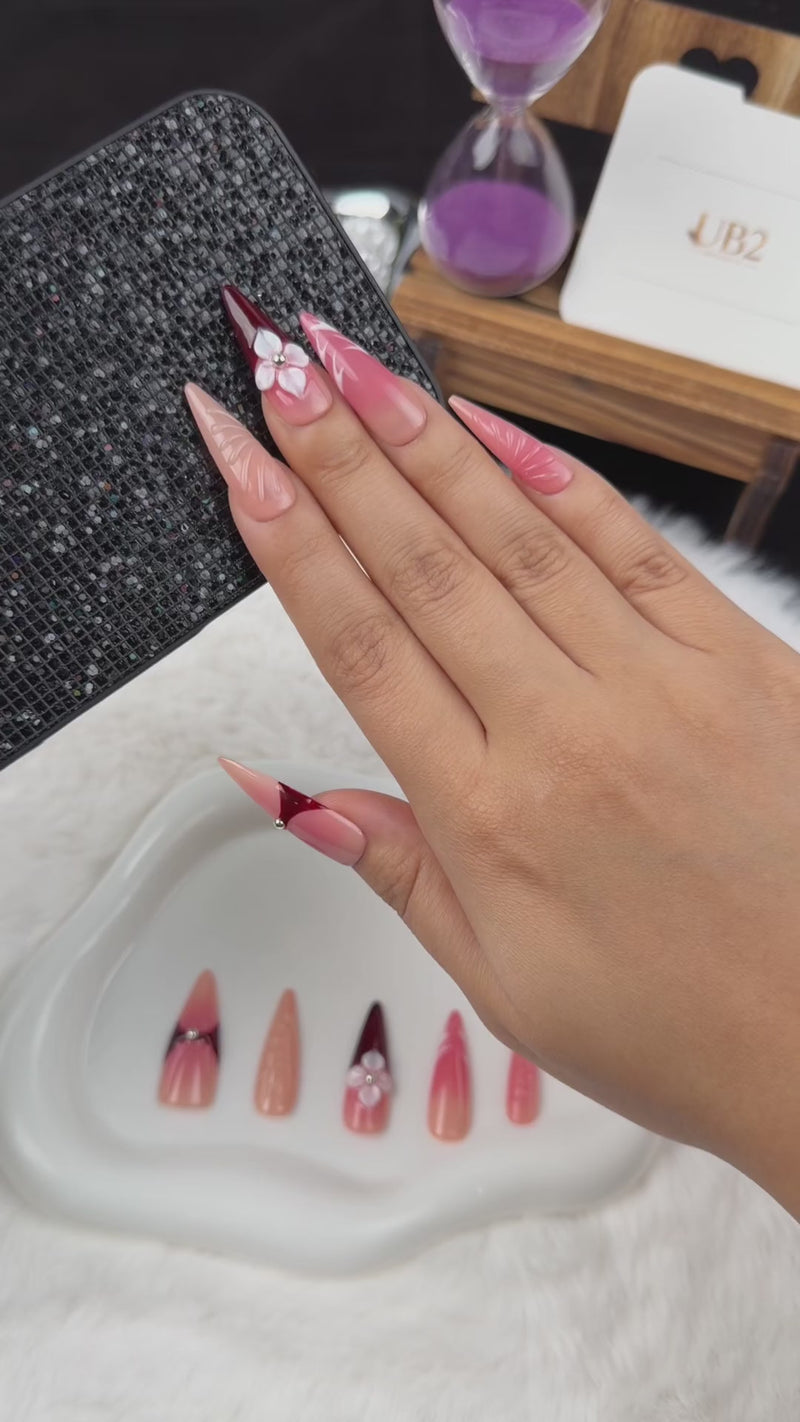 Step-by-step application of Crimson Petal red and nude pink floral stiletto press-on nails