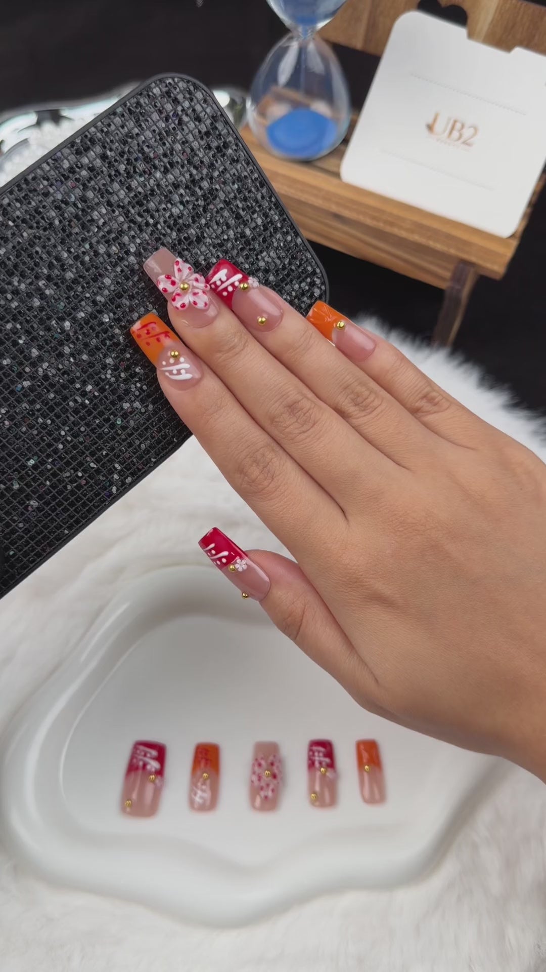 Load video: Step-by-step application of Coral Ribbon coral and orange floral square press-on nails