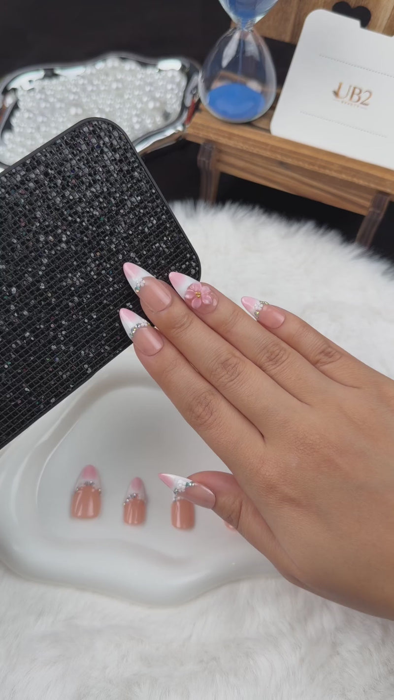 Step-by-step application of Blush Tiara pink French tip press-on nails with sparkle and floral accents