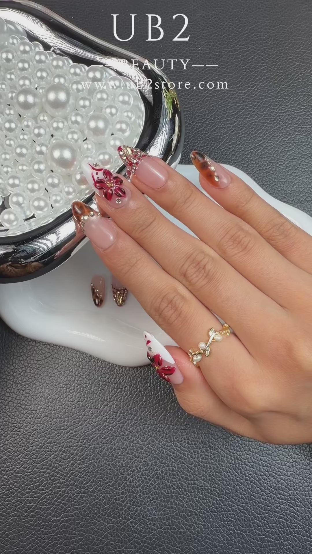 Load video: Step-by-step application of Red French tip floral tortoiseshell stiletto press-on nails