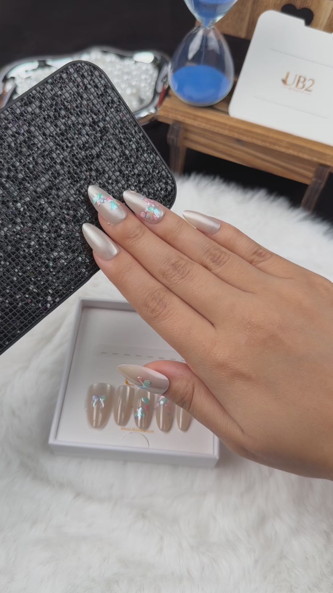Load video: Step-by-step application of Opal Bouquet pearl-toned bow and floral almond press-on nails